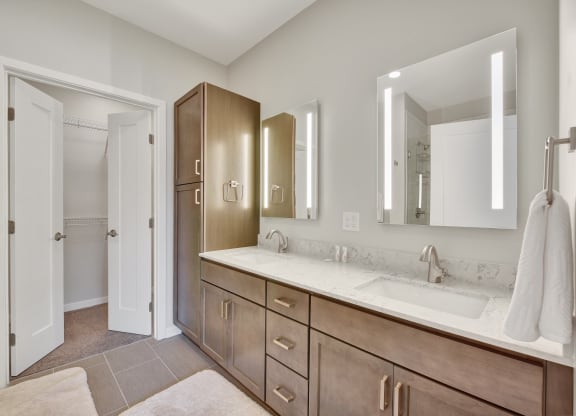 a bathroom with a large vanity with two sinks and two mirrors