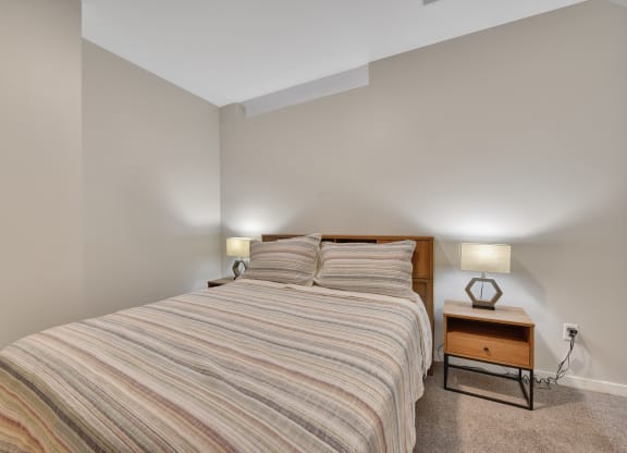 a bedroom with a bed and two night stands
