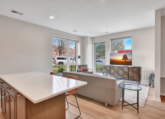 a kitchen with an island and a living room with a couch and a coffee table