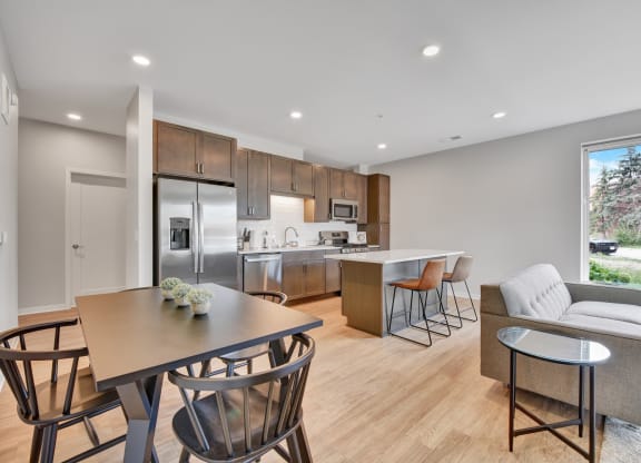 a kitchen and living room with wood flooring and a large window