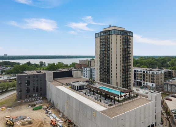 a view of a tall building with a pool in front of it