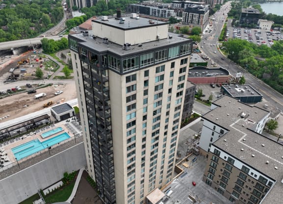 a tall building with many windows and a blue pool in front of it