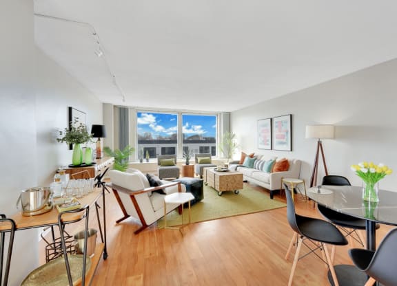 a living room with a couch and a table and a window