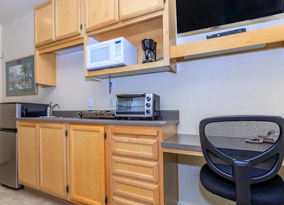 A Kitchen With Wooden Cabinets at Atrium Garden Apartment Homes, LLC, California