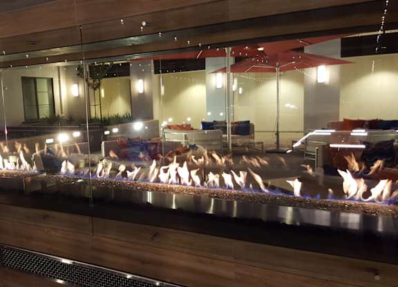 A group of people are sitting in a row on a wooden bench at Catalyst Mountain View, Mountain View, CA