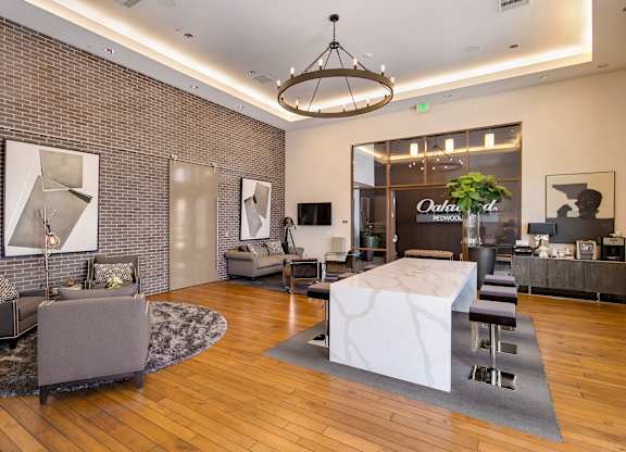 A modern living room with a white marble coffee table and a chandelier hanging from the ceiling. at Cirrus Redwood City Apartments, Redwood City, 94061
