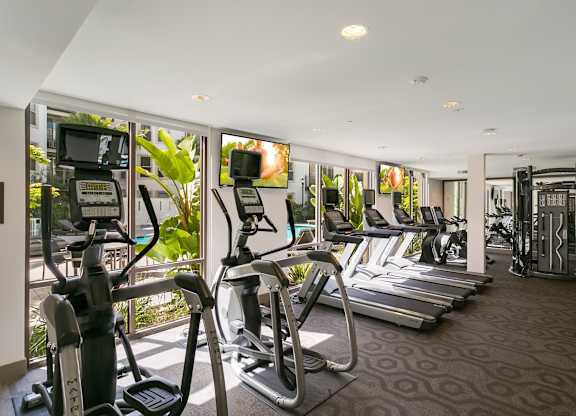A gym with treadmilers, elliptical machines and other cardio equipment. at Cirrus Redwood City Apartments, California, 94061