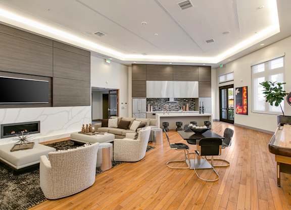 A modern living room with a fireplace and a dining table. at Cirrus Redwood City Apartments, Redwood City, 94061