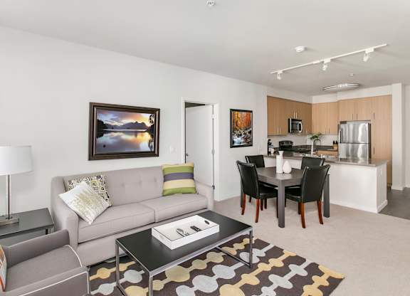 A living room with a grey couch and a coffee table. at Cirrus Redwood City Apartments, Redwood City, 94061