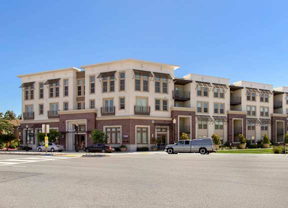 A large building with a parking lot in front of it. at Cirrus Redwood City Apartments, California, 94061