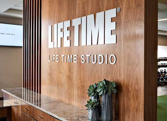 A wooden wall with the words at One West, New York, NY,10004