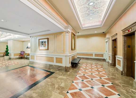 A large, well-lit lobby with a marble floor and a checkerboard pattern. at One West,New York, 10004