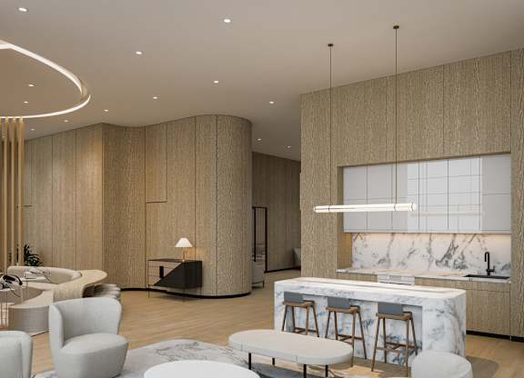 A modern kitchen with a marble countertop and bar stools.