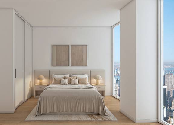 A bedroom with a large bed and a city view.
