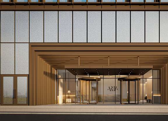 A modern building with a large entrance and glass windows.