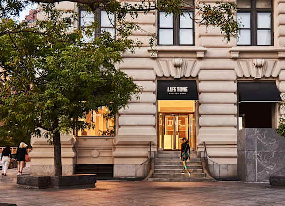 A building with a black awning that says at One West,  New York,10004