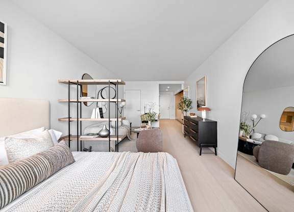 A bedroom with a large bed and a mirror on the wall at One West,  New York,10004