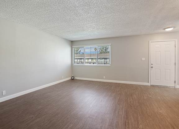 A room with a window and a door.