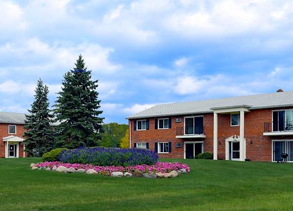 A large building with a lawn in front of it.