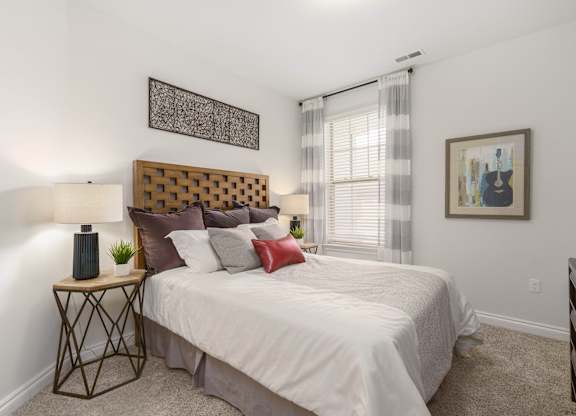 a bedroom with a large bed and a window