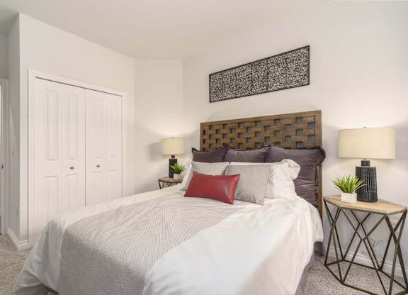 a bedroom with a large bed and a closet