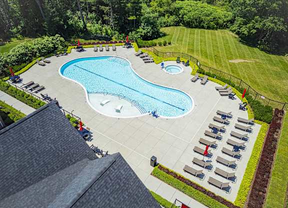 A large outdoor swimming pool surrounded by sun loungers.