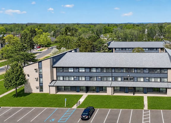 A large building with a parking lot in front of it.