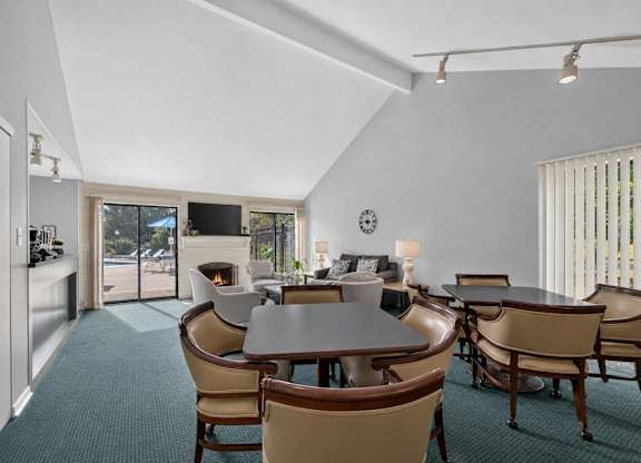 A dining room with a table and chairs.