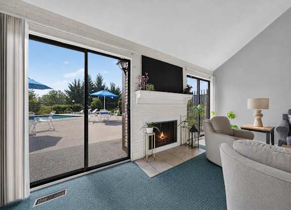A living room with a fireplace and sliding glass doors.