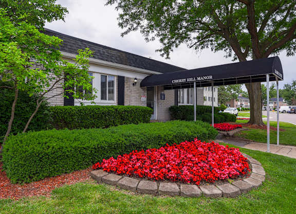Cherry Hill Manor is a residential building with a landscaped front yard.