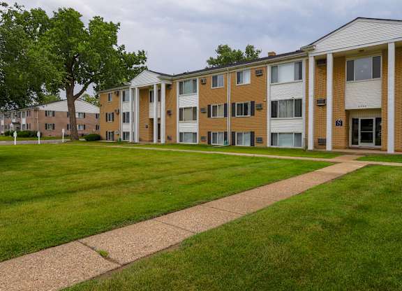 A long building with a lawn in front.