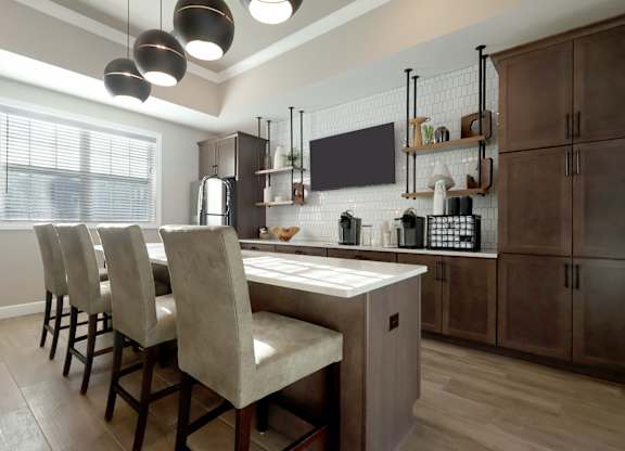 A kitchen with a table and chairs.