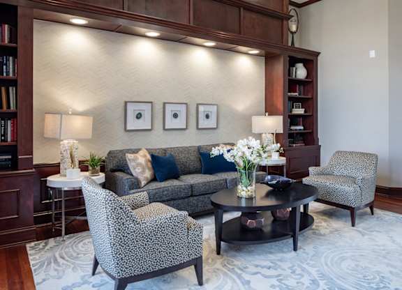 a living room with a couch and chairs and a table