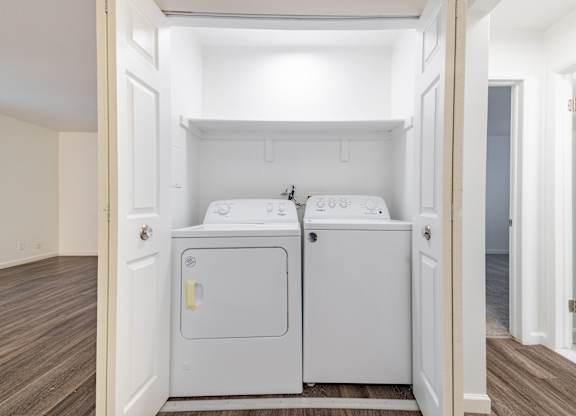 A small laundry room with a washer and dryer.