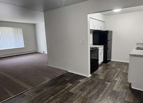 A kitchen area with a refrigerator, microwave, and oven.