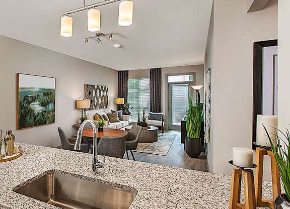 A modern kitchen with a large island and a sink.