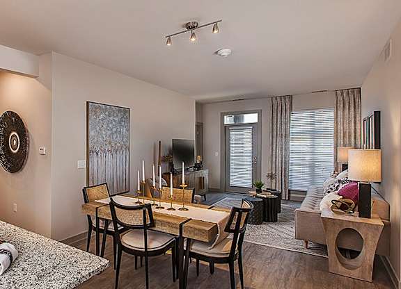 A modern kitchen with a breakfast bar and a dining area.