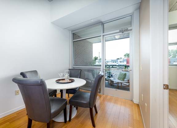 A dining room with a table and chairs.