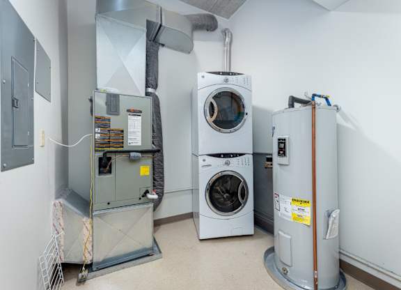 A room with a washing machine, dryer, and furnace.
