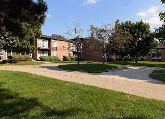 A grassy area in front of apartment buildings.