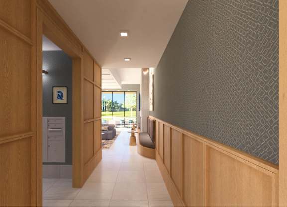 A hallway with a carpeted floor and a wall on the right side.