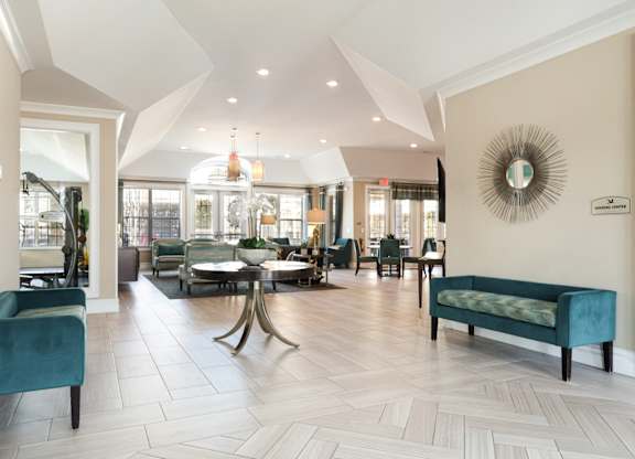 A large room with a table and chairs in the middle.