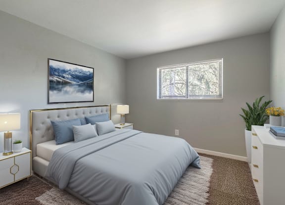A bedroom with a large bed, a nightstand with a lamp, and a painting on the wall.
