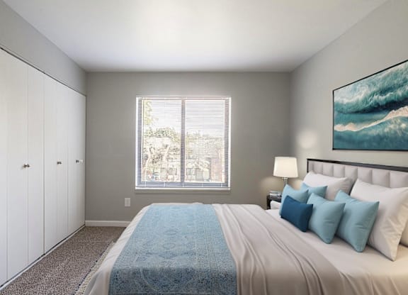 A bedroom with a large bed and a painting on the wall.