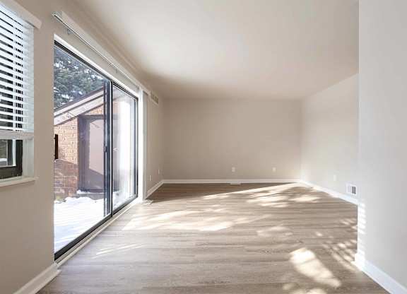 A sunny room with a sliding glass door.
