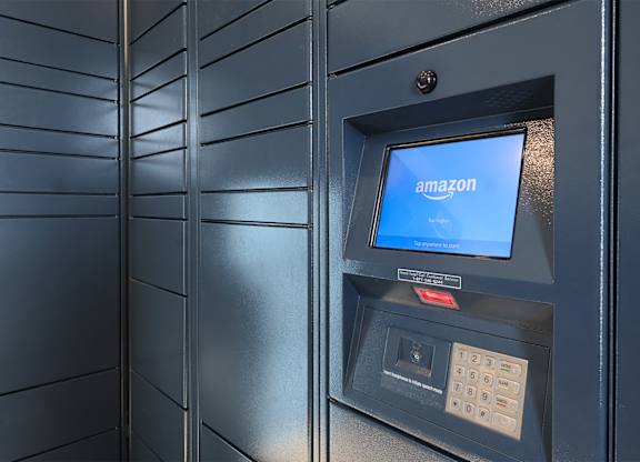A black Amazon vending machine with a blue screen.