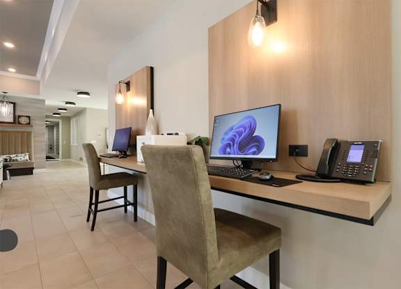 A modern home office with a desk, chair, and computer.