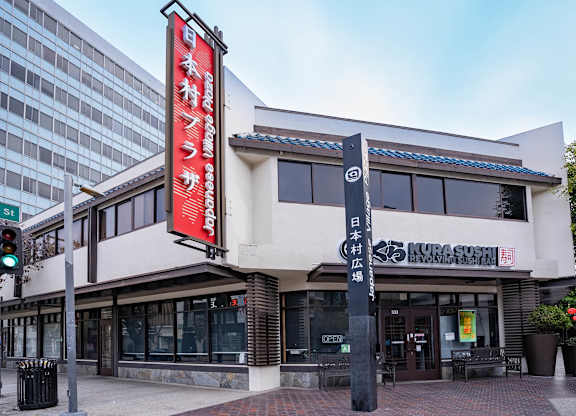 A restaurant with a red signboard on the front.
