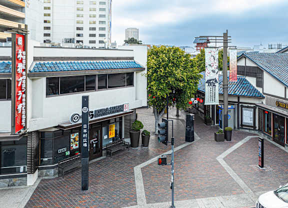 A white car is parked on the right side of the street.
