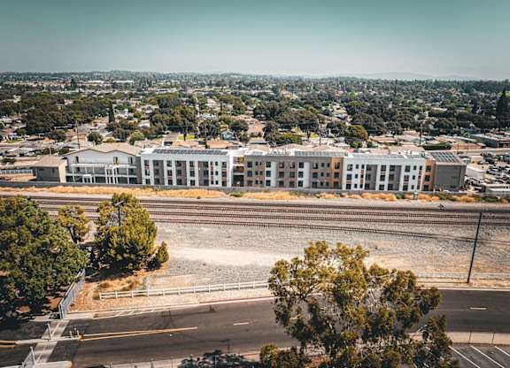 A train station with a train on the tracks.